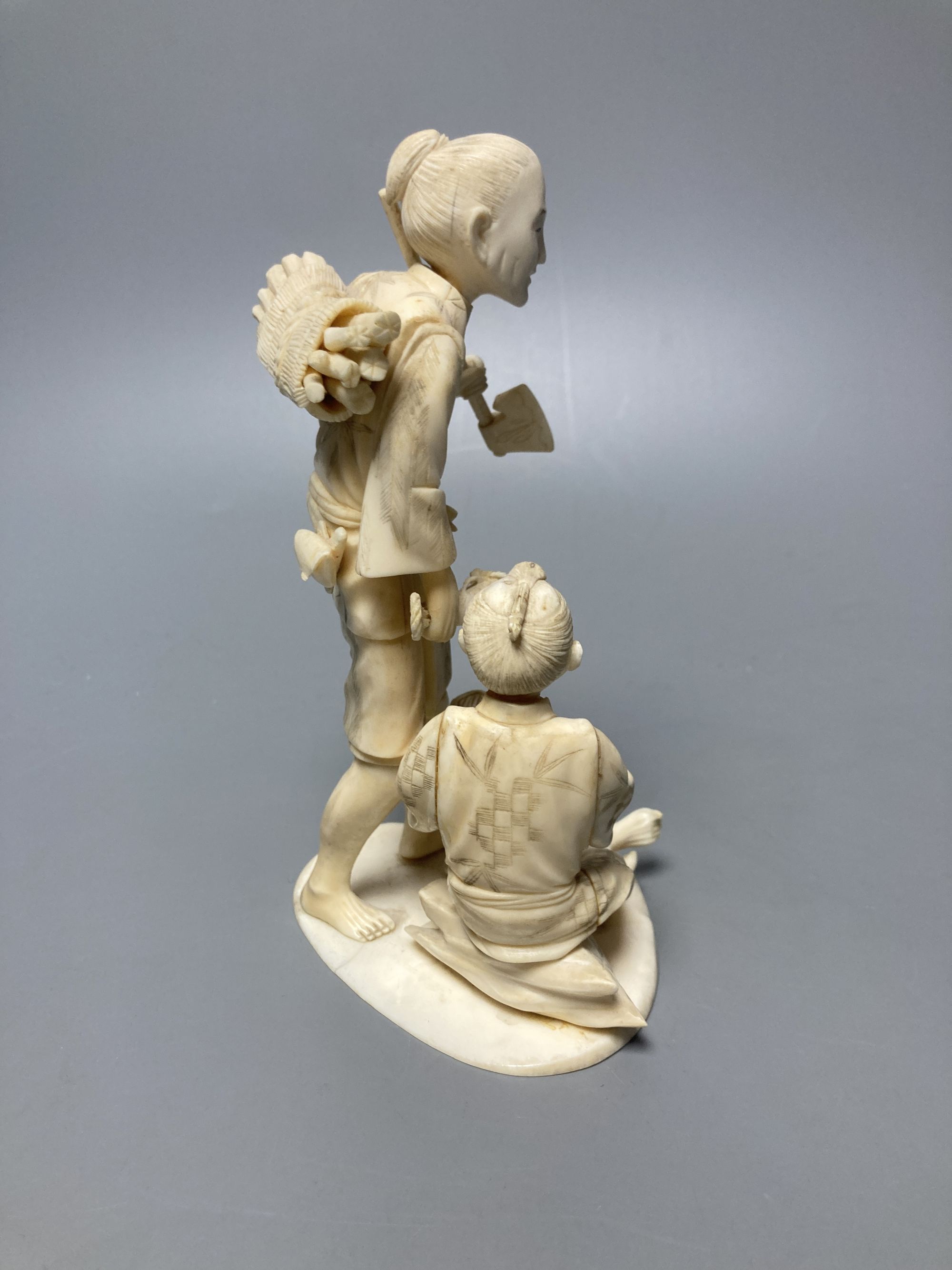 A Japanese sectional ivory okimono of woodsman, height 16cm